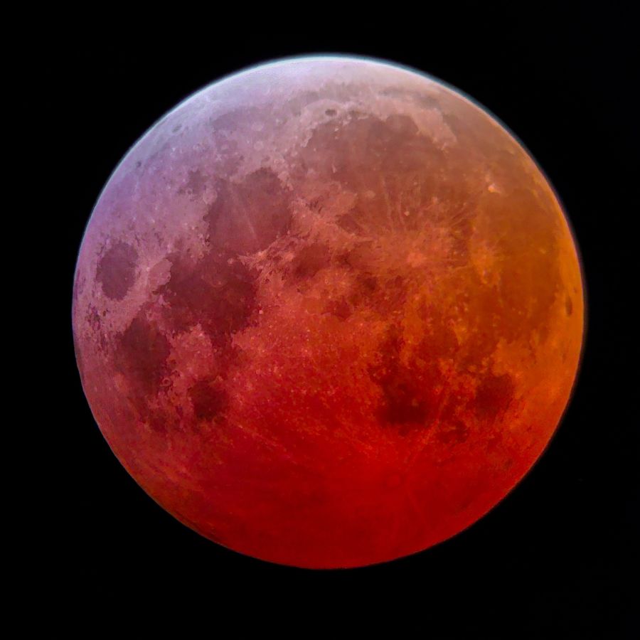 The Moon in total eclipse, deep red with a bright pale limb