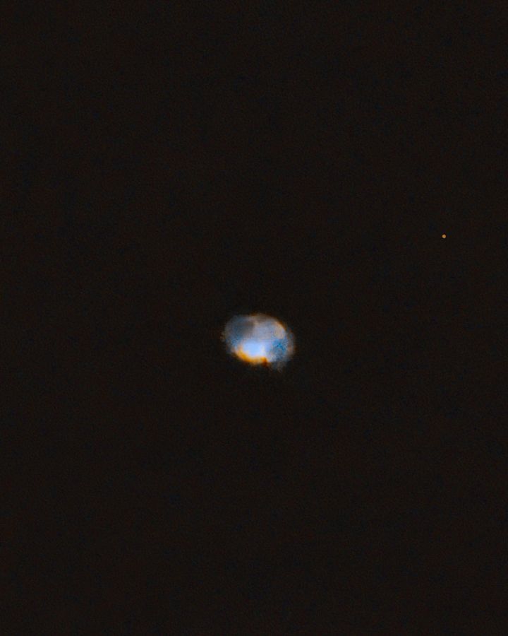 The small teal Dumbbell Nebula