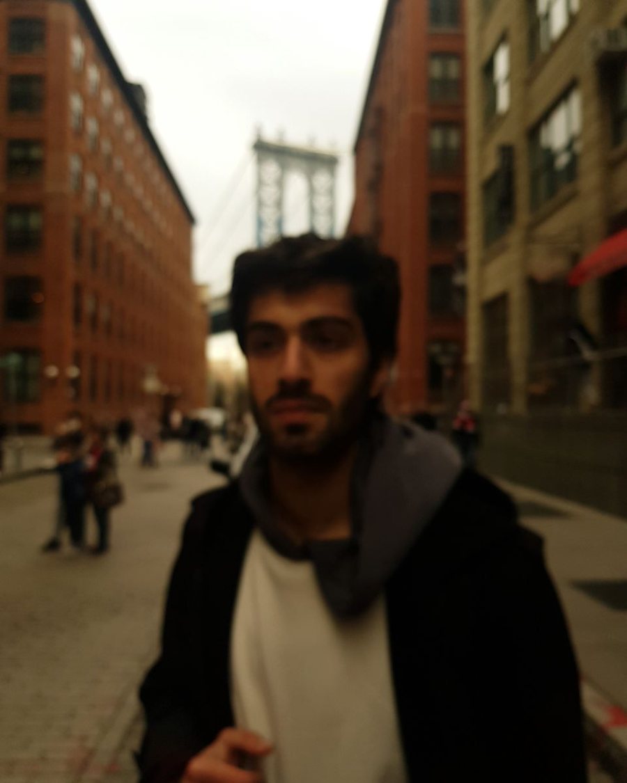 Kasra Sinaei in Brooklyn with the Manhattan Bridge behind
