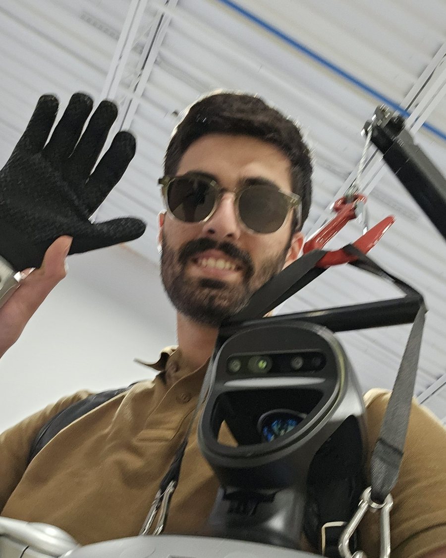 Kasra Sinaei with a robot in the lab